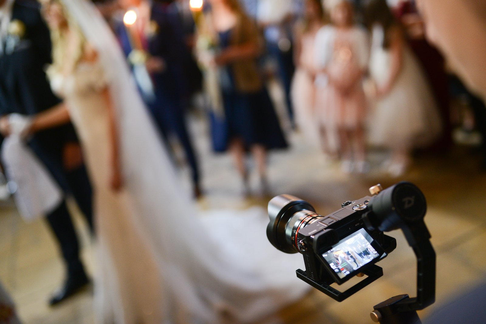 Videographer filming a wedding ceremony with a professional camera