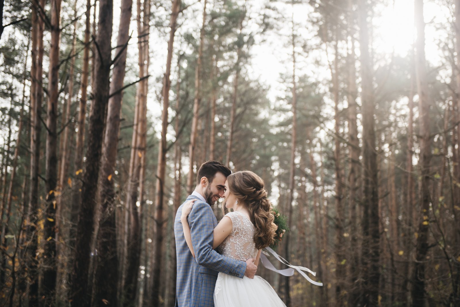 Wedding couple embracing in a quiet forest