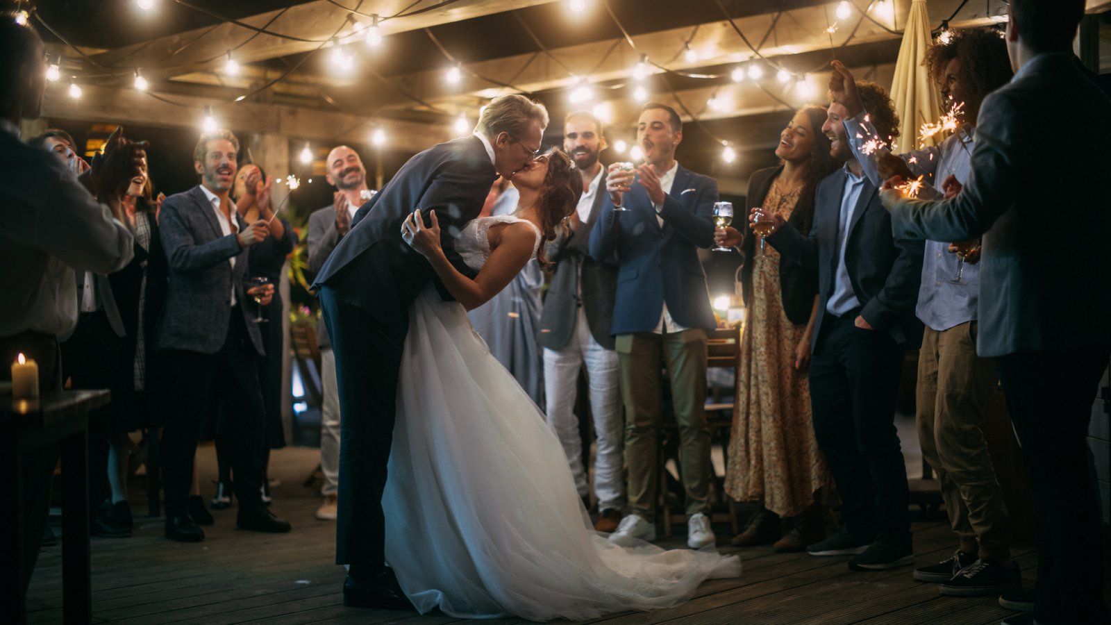 Bride and groom celebrating at an evening wedding reception