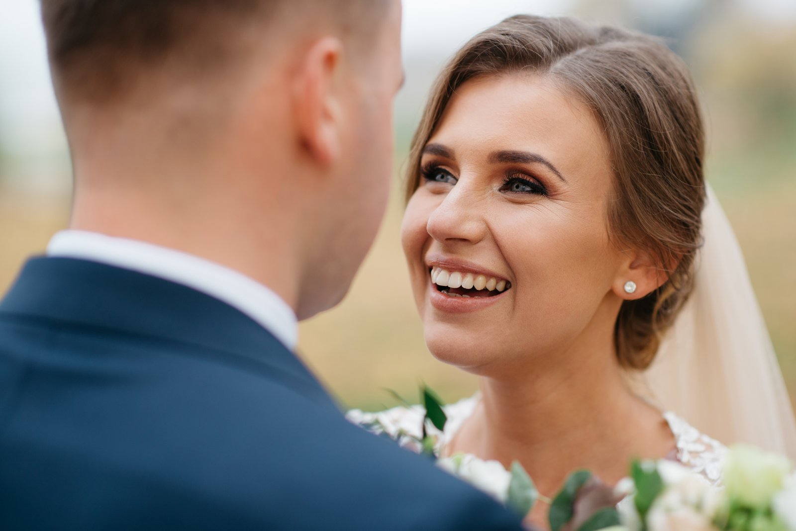 Bride smiling at the groom during a wedding portrait
